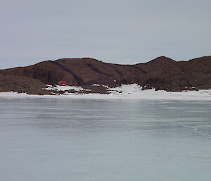 Watts hut on edge of frozen fjord