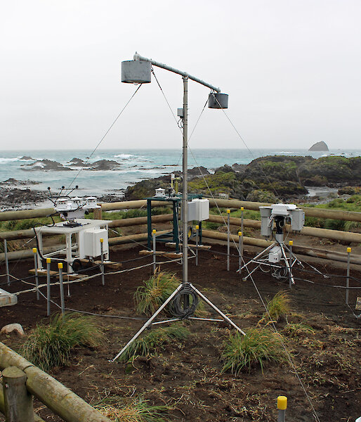 A range of atmospheric instruments inside a fenced area on Macquarie Island.