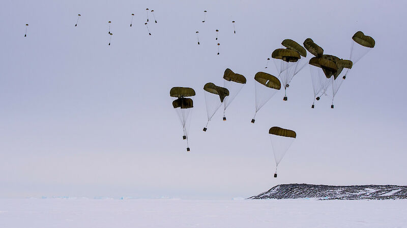 Parachuted cargo descending to ground