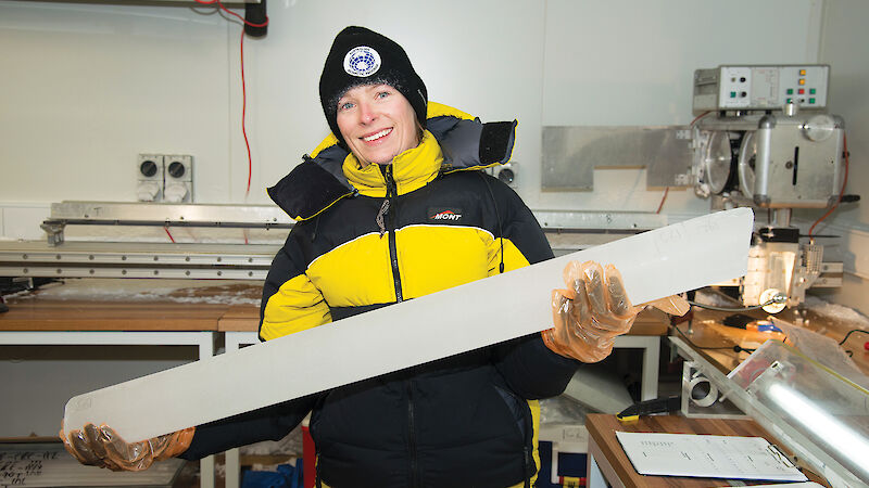Glaciologist, Dr Tessa Vance, holds an ice core in the laboratory at the Institute for Marine and Antarctic Studies in Hobart.
