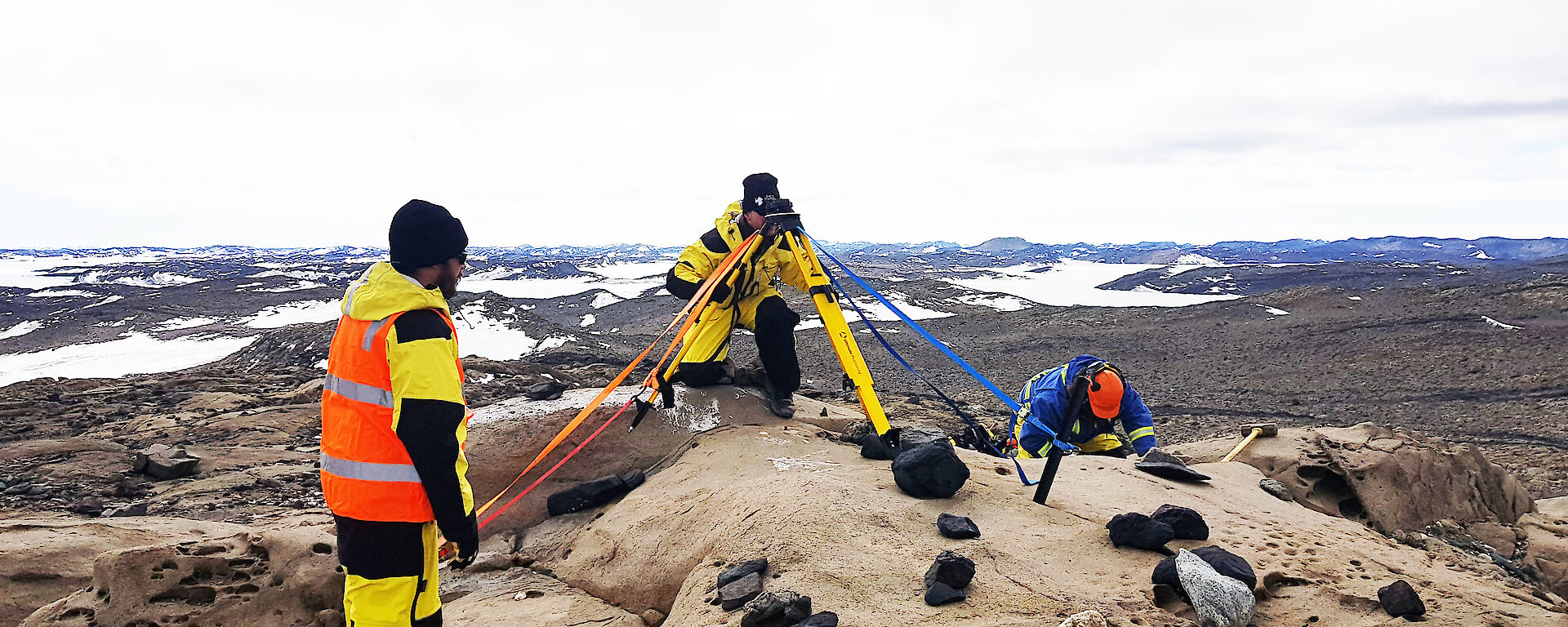 Two expeditioners using surveying equipment
