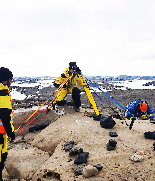 Two expeditioners using surveying equipment