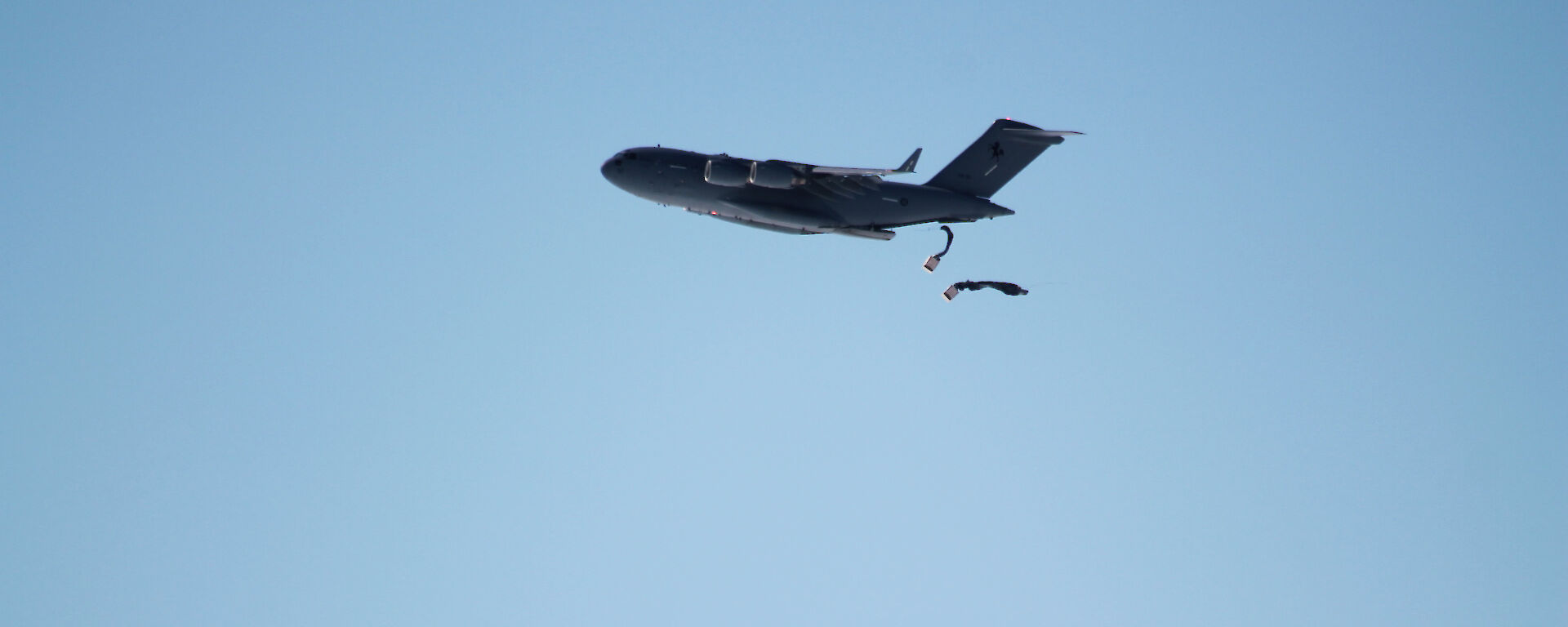Two parachutes being deployed from a plane