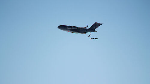 Two parachutes being deployed from a plane