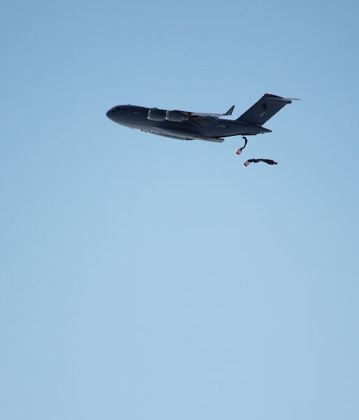 Two parachutes being deployed from a plane