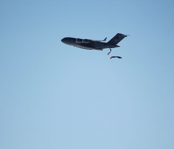 Two parachutes being deployed from a plane