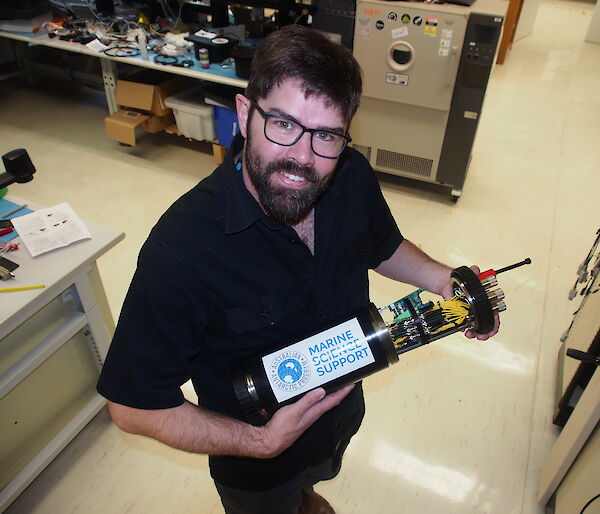 Australian Antarctic Division Electronics Design Engineer, Mark, Milnes with the test device for the Nuyina’s fibre optic and electrical cables, which was designed and built in-house.