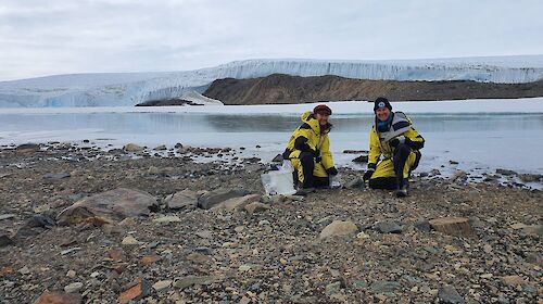 Dr Kathryn Brown and Dr Catherine King on a rocky shore beside a lake