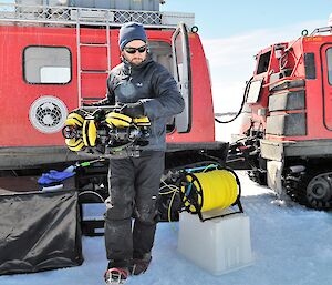 man carries mini-sub