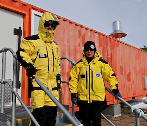 two people outside shipping container