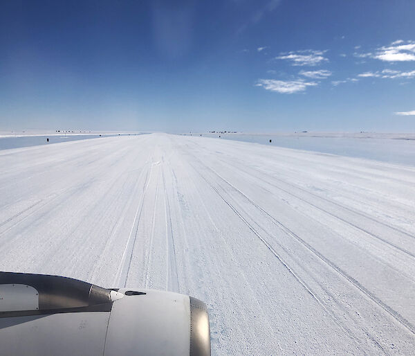 view of ice runway through airplane window