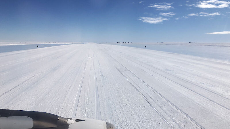 view of ice runway through airplane window