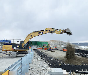 Excavator dumping a load of rocks