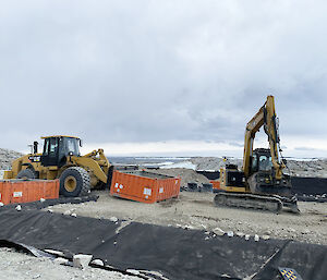 Bulldozer and excavator on the mega pile