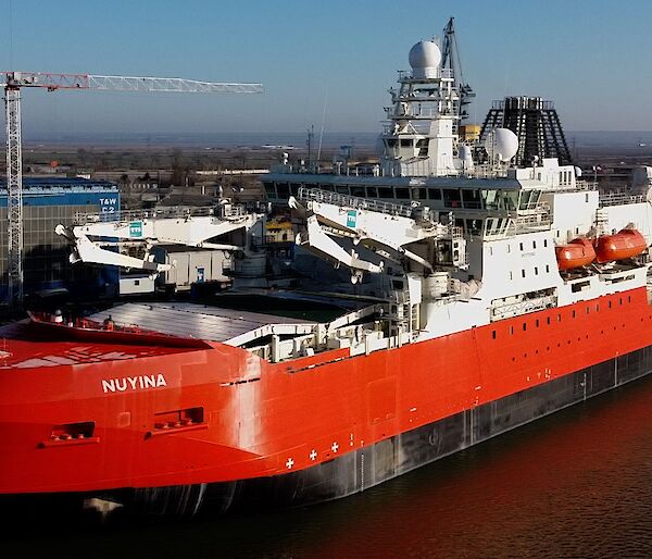 Aerial photo of the icebreaker ship beside a wharf in Romania.