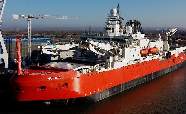 Aerial photo of the icebreaker ship beside a wharf in Romania.