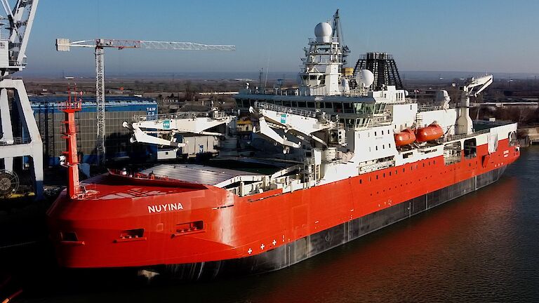 Aerial photo of the icebreaker ship beside a wharf in Romania.