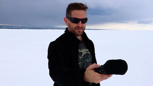 Man with audio recorder on ice