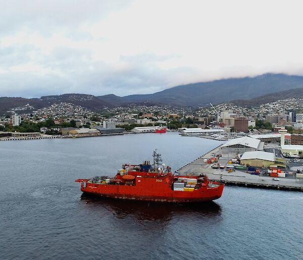 orange ship with Hobart in background