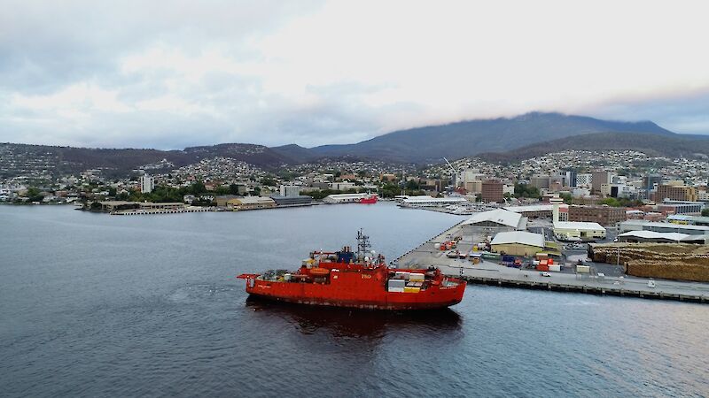 orange ship with Hobart in background
