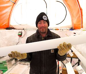Glaciologist holding an ice core.