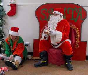 Santa and elf helper delivering presents and Casey Station on Christmas Day