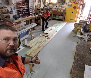 A long wooden base on the floor inside the carpenter’s workshop