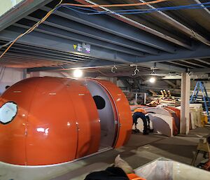 Inside view of workshop with round huts being built