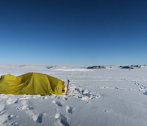 A bivvy bag with occupant set up in the snow