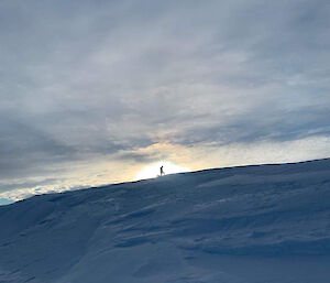 An expeditioner on top of a ridge