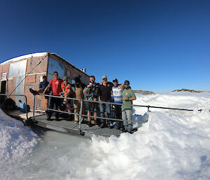 A group of expeditioners outside a field hut