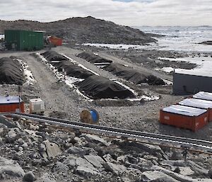 Seven piles of remediated soil along the coast at Casey