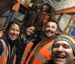 A group of expeditioners stocking the fridges