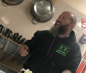 A man holding a tray of cookies