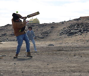 A man mis-hitting a ball while batting in the cricket game