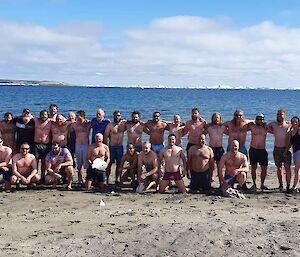 A group photo of the bathers on the beach at Davis