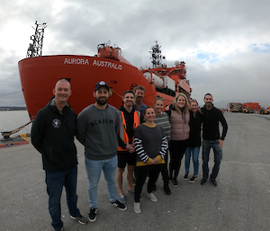 The hydrography team stop for a photo in front of the Aurora Australis ship in Hobart