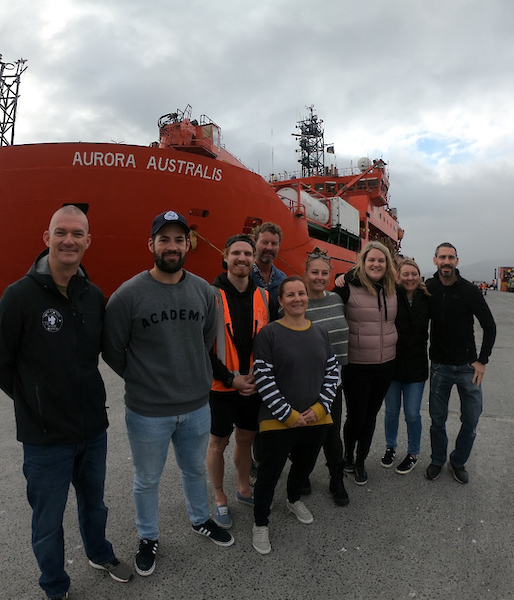 The hydrography team stop for a photo in front of the Aurora Australis ship in Hobart
