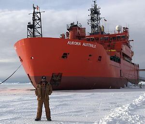 Cam stands on the white fast ice in front of the red AA during V1 resupply last November