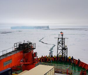 The AA’s red hull is contrasted with the gloomy sky as it breaks through a lead in the white pack ice on it’s way south last November