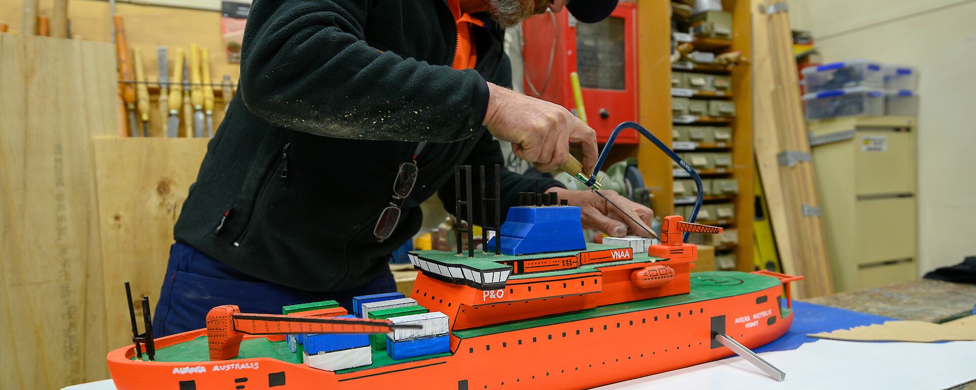 Grant in the process of building a scale model of the Aurora Australis ship in the Davis workshop