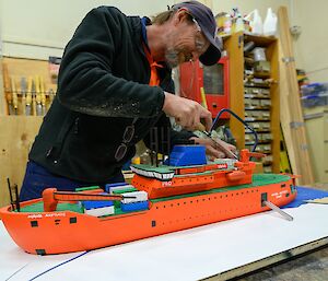 Grant in the process of building a scale model of the Aurora Australis ship in the Davis workshop