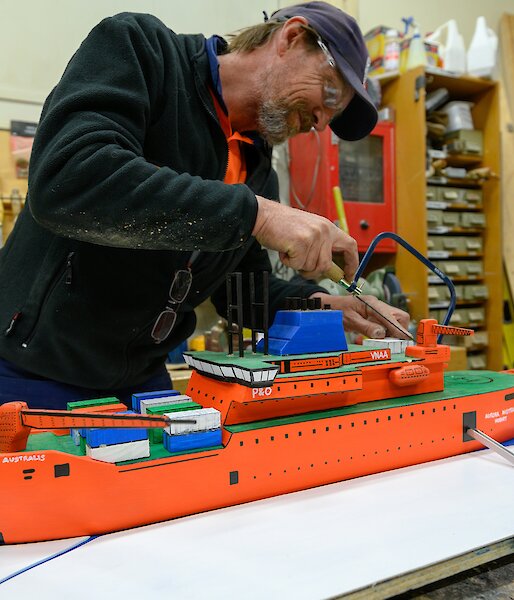 Grant in the process of building a scale model of the Aurora Australis ship in the Davis workshop