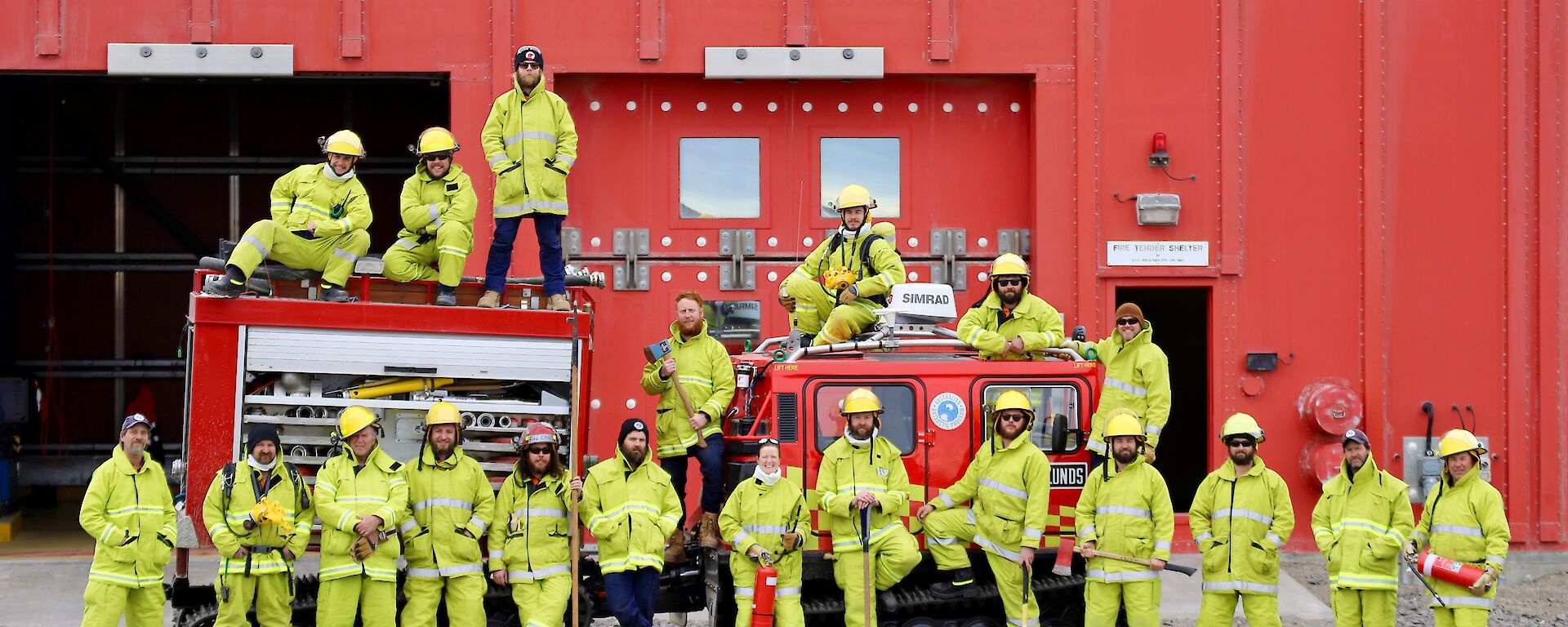 The summer fire team personnel pose outside the red emergency vehicle shelter