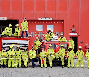 The summer fire team personnel pose outside the red emergency vehicle shelter