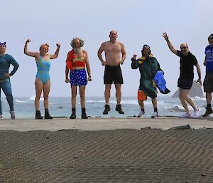 Seven swimmers about to enter the water