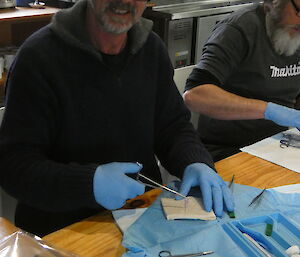 An expeditioner learning to suture