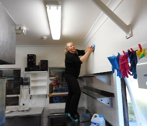 Chef cleaning kitchen walls