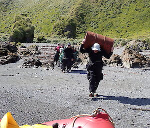 Expeditioner with fuel drum on shoulders