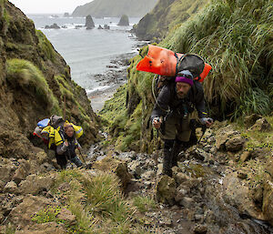 Two Rangers climb up a rocky track